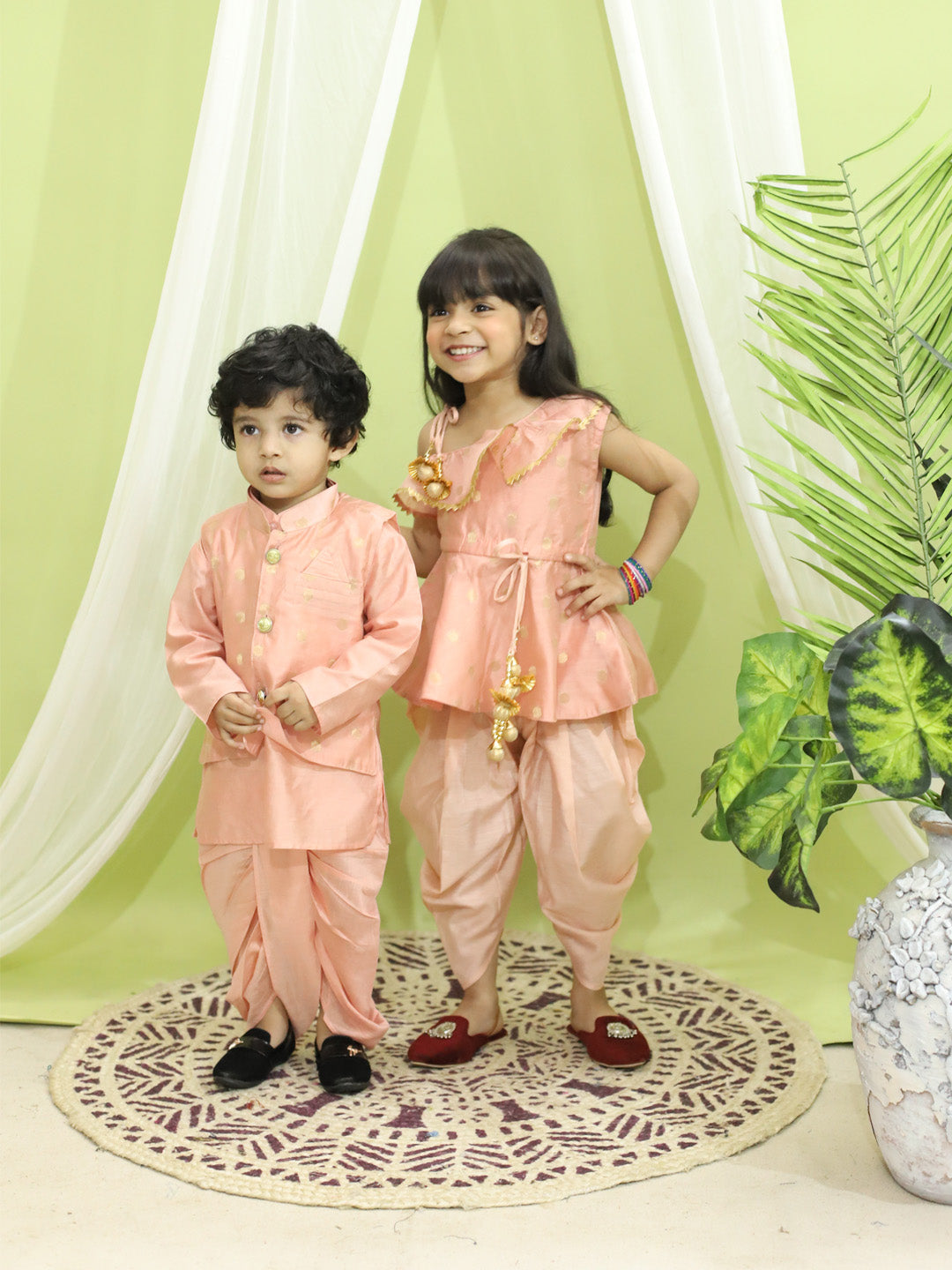 BownBee Sibling Set Chanderi Jacket with Chanderi Dhoti Kurta for Boys- Peach with Chanderi Silk One Shoulder Peplum with Dhoti- Peach